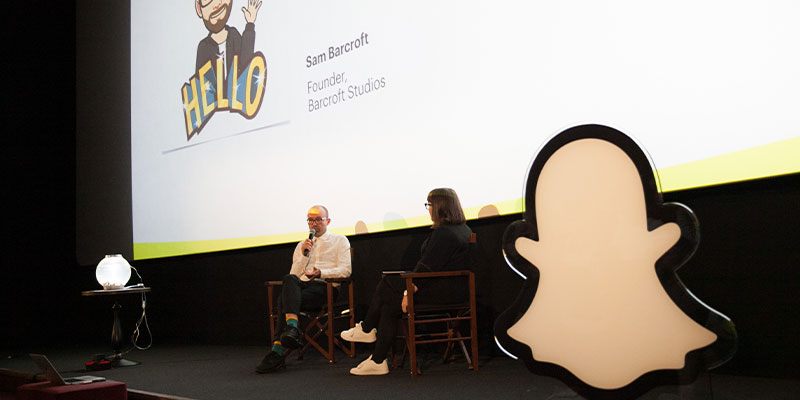 Conversation on stage with two people front of Snap logo
