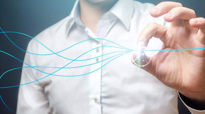 Picture of a man in a white shirt holding a blue wire