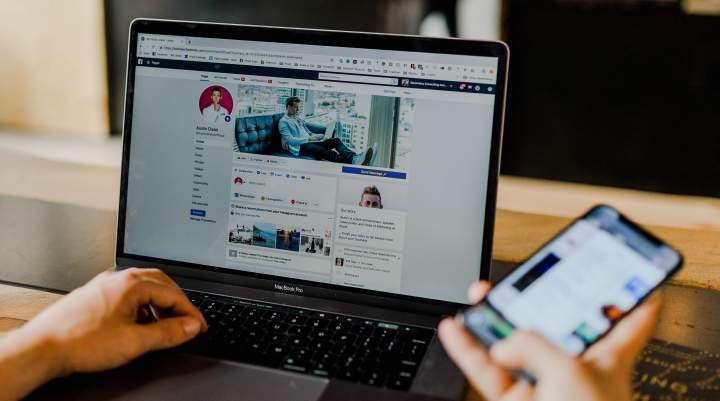 Image of social media platforms on a laptop and smartphone.