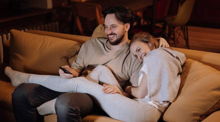 man and woman watching tv