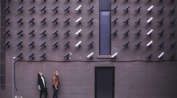 Two ladies looking at CCTV surveillance cameras