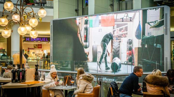 Lakeside shopping centre audience in front of screen