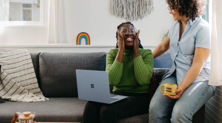 Two women looking at a laptop