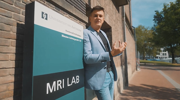 A man standing next to a sign