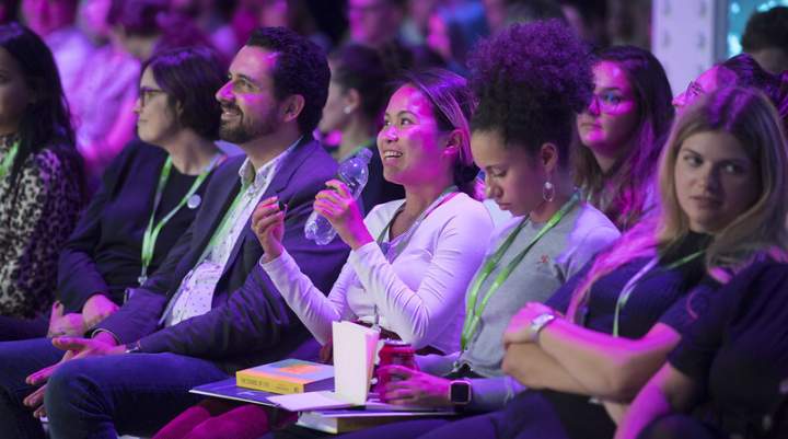 A woman asking a question at an event