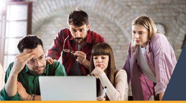 People crowded around a laptop