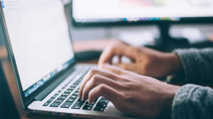 Man's hands on a laptop keyboard 