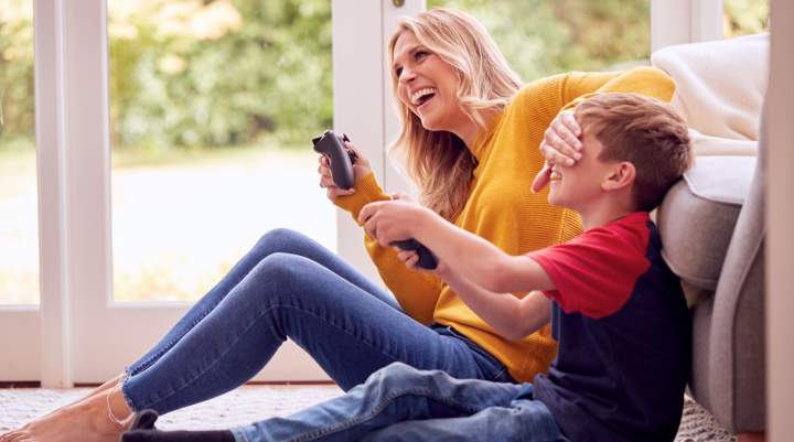 A mum and her son gaming on console together