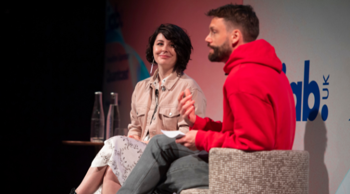 Two people on stage at an IAB event