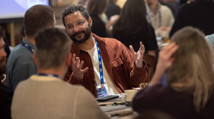 Member sat around a table in discussion 